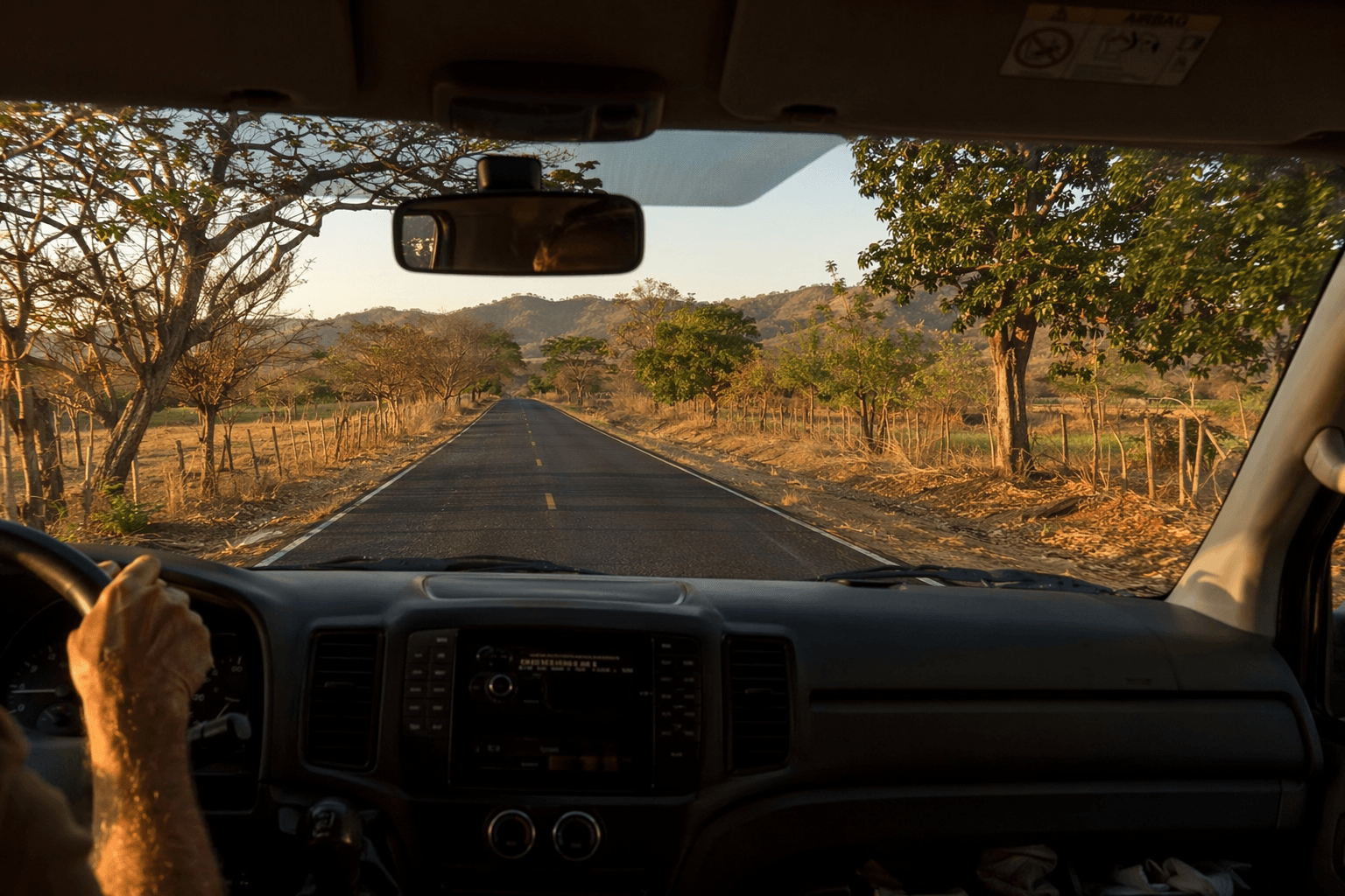 View from inside shuttle van driving through Guanacaste dry forest